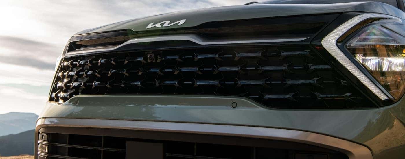 The grille on a green 2023 Kia Sportage for sale.
