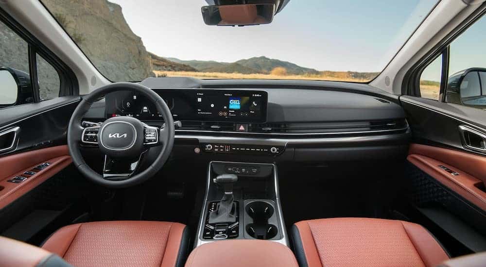 The black and brown interior and dash in a 2026 Kia Carnival MVP.