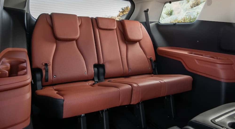 The brown rear seating area in a 2026 Kia Carnival MVP at a Kia dealer near Sevierville.