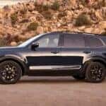 A navy blue 2025 Kia Telluride parked off-road