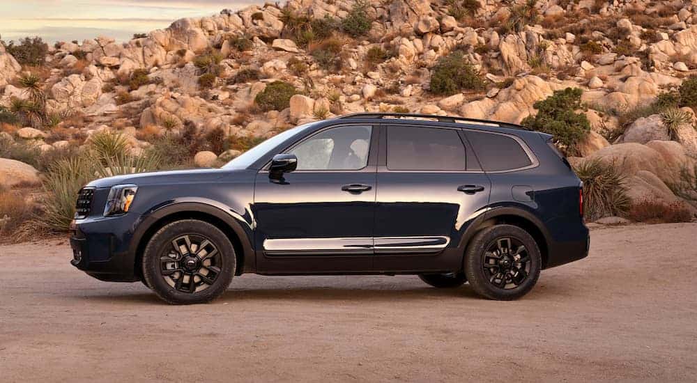 A navy blue 2025 Kia Telluride parked off-road
