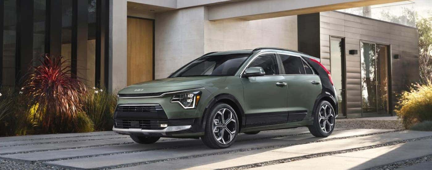 Green 2026 Kia Niro for sale parked on a driveway.