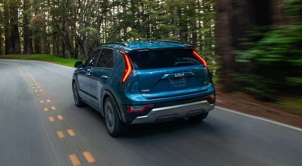View from the back at an angle of a blue 2025 Kia Niro Plug-in Hybrid.