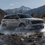 Grey 2026 Kia Sorento driving through a creek