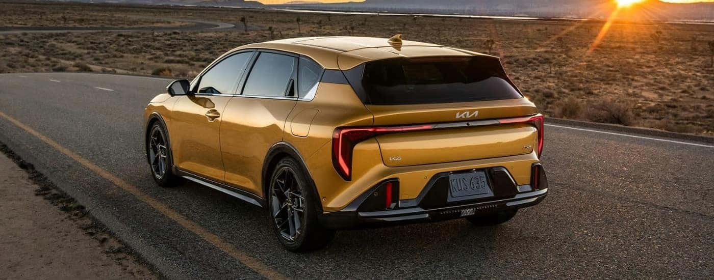 A gold 2026 Kia K4 Hatch from the rear after leaving a Kia dealer near Oak Ridge..