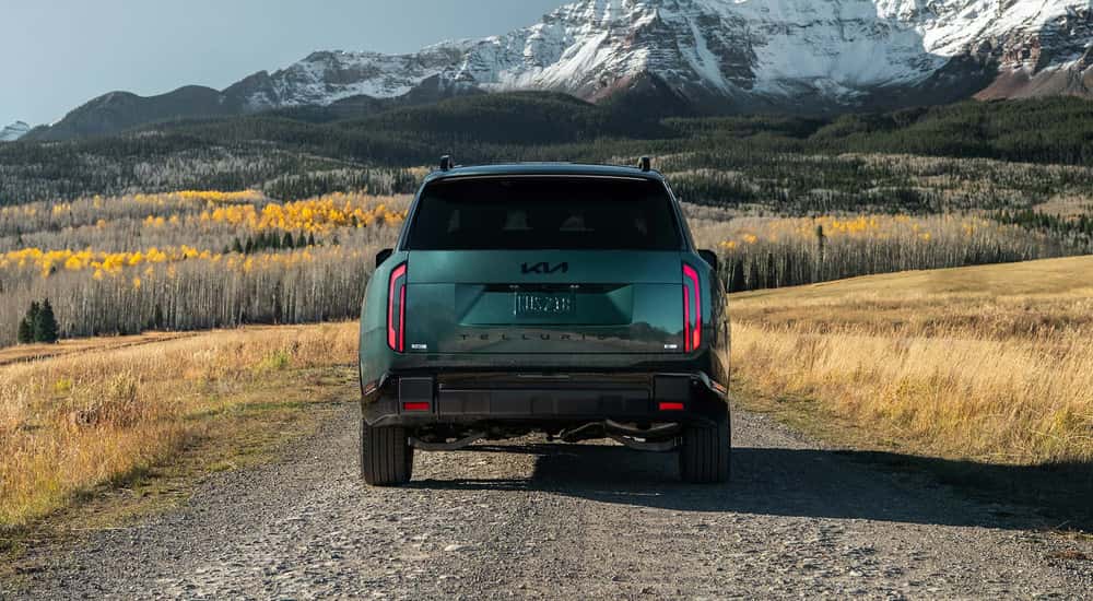 Rear of a green 2027 Kia Telluride on a gravel road