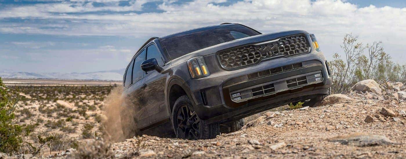 A gray 2025 Kia Telluride off-roading on a trail