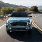 Blue 2026 Kia Seltos driving on a curvy road