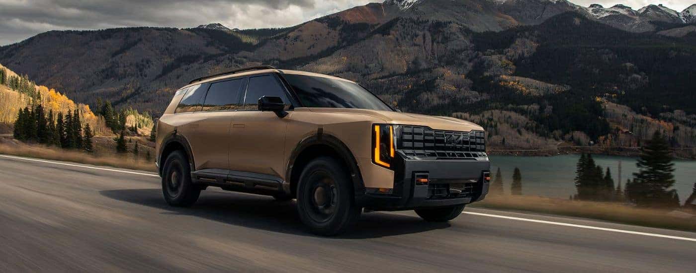 Brown Matte 2027 Kia Telluride X-Pro SX with assertive front fascia driving on a road.