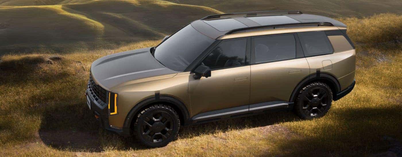 Brown Matte 2027 Kia Telluride X-Pro SX Prestige aerial view in a field.