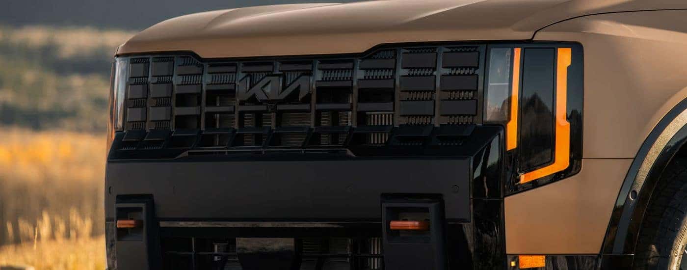 Brown Matte 2027 Kia Telluride X-Pro SX Prestige front with 2 tow hooks.