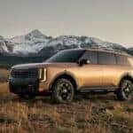 A brown 2027 Kia Telluride X-Pro SX Prestige shown parked by mountains.