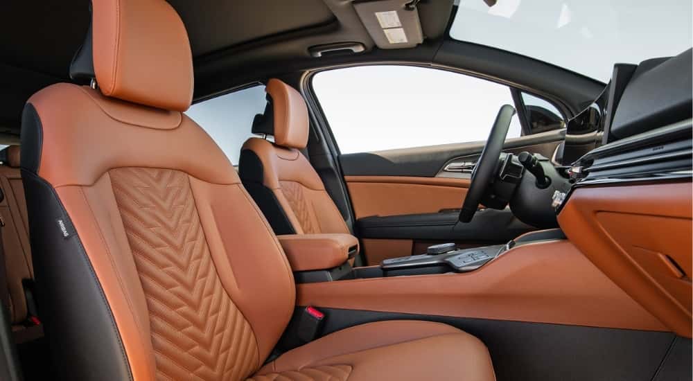 Front seat view of a 2026 Kia Sportage with brown leather.
