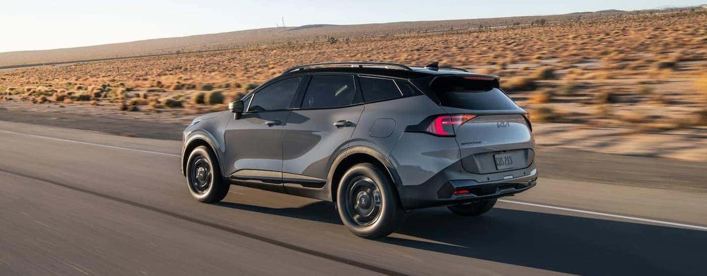 A gray 2026 Kia Sportage driving on a highway.