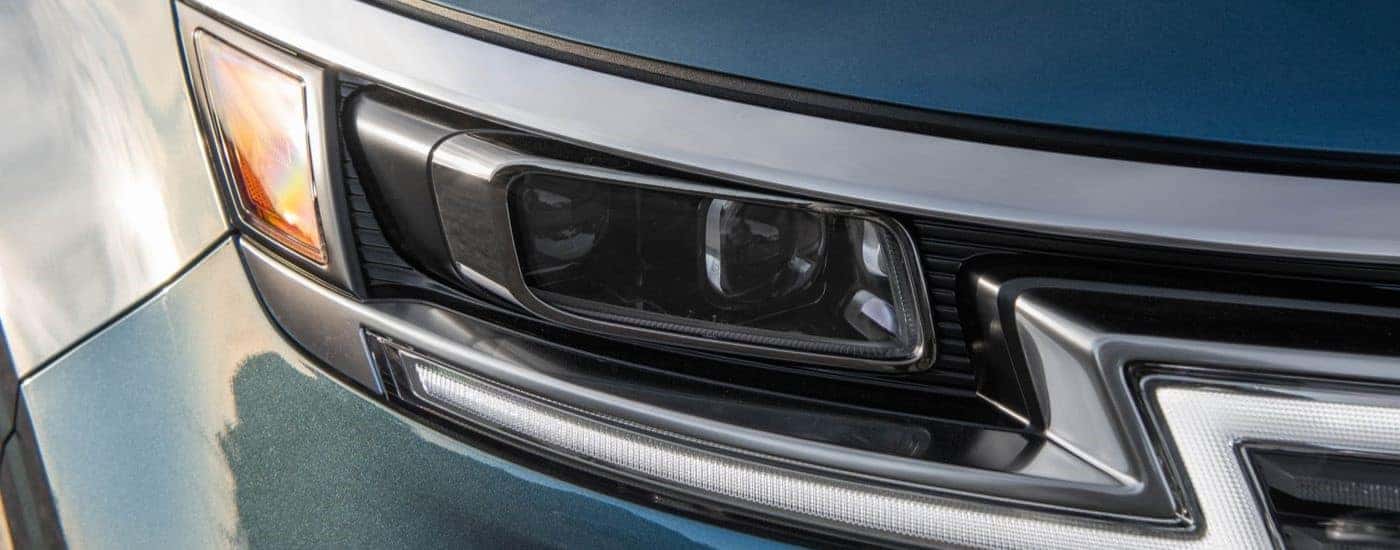 Close up of headlight on a 2024 Kia Carnival MPV.
