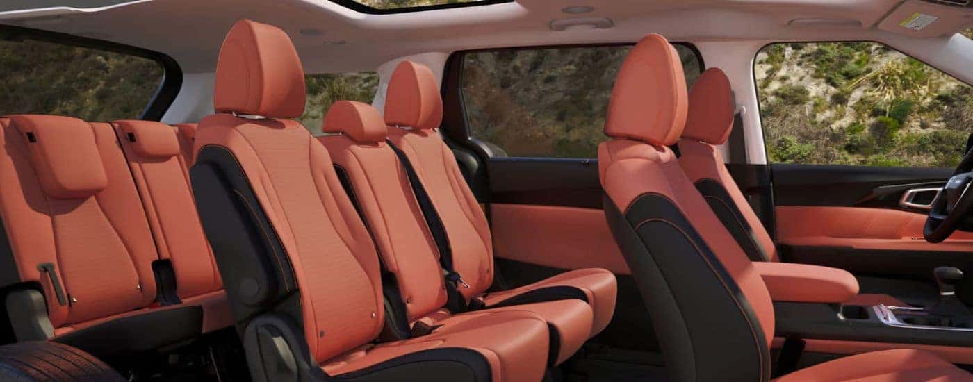 Light red three-row seating in a 2027 Kia Carnival MPV SX Prestige.