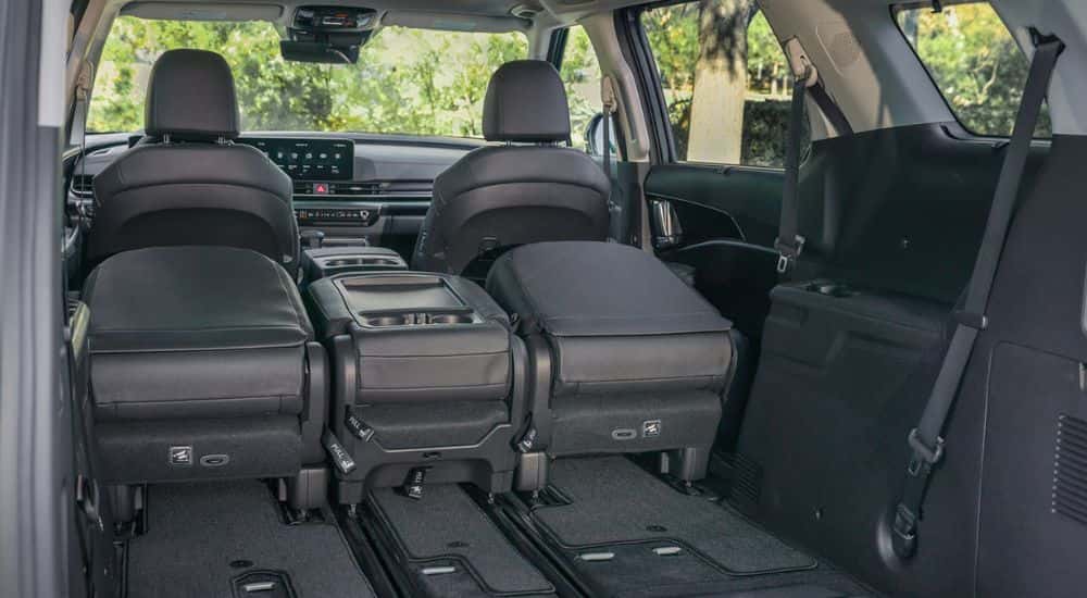 Rear seats folded down in a 2027 Kia Carnival SX Prestige.