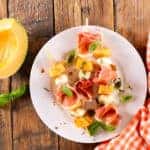 melon salad with mozzarella and prosciutto ham