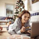Close up of a young woman buying presents online