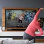 Woman exercising at home with an instruction video