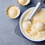 Homemade vanilla, caramel ice cream in vintage bowl Organic product on a grey stone background Top view