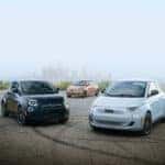 Three 2024 Fiat 500e models parked in a lot, showcasing modern eco-friendly vehicles in a clean, organized space.