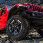 Shot of the wheels and under carriage of a Jeep Wrangler parked on some rocks