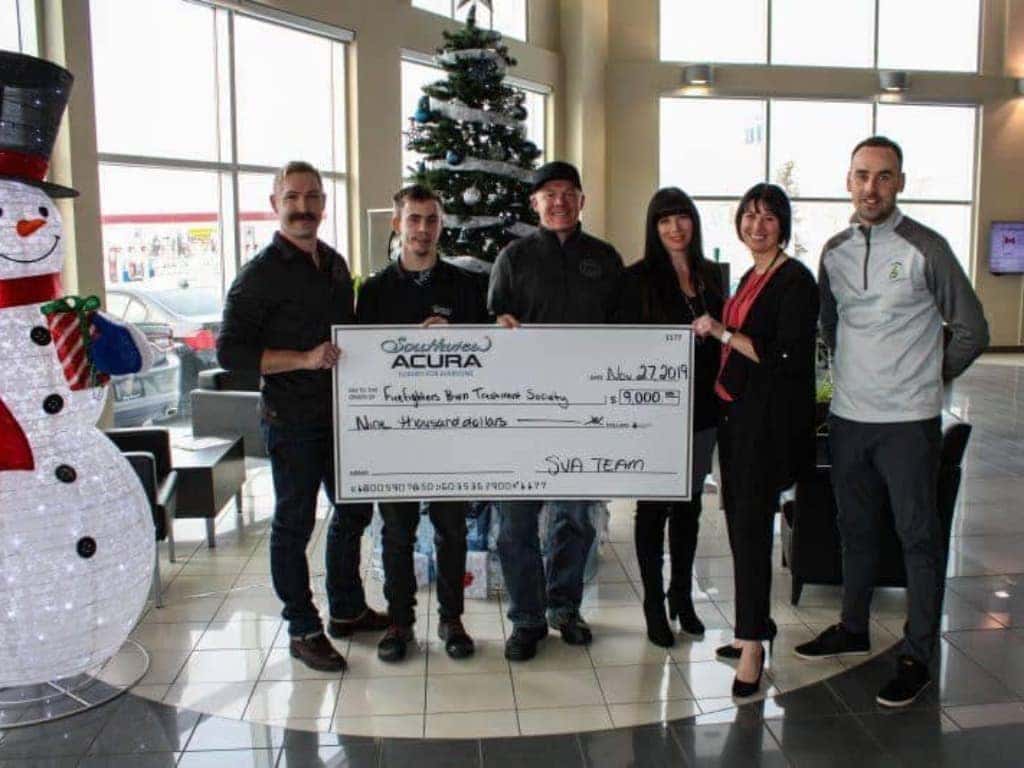 Edmonton-Firefighters-Burn-Treatment-Society-holding-a-check