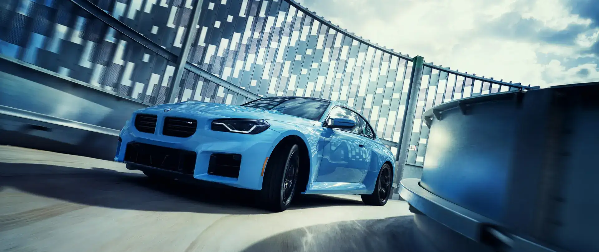 Angled view of a 2024 Zandvoort Blue M2 Coupe driving