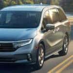 Silver-gray 2021 Honda Odyssey driving on road