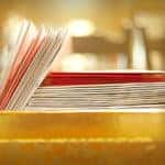 A stack of red and white Christmas card envelopes