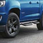 A blue 2021 Chevrolet Colorado from the left headlight to the tires.