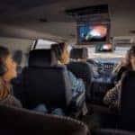 A family inside the Chevrolet Tahoe SUV watching the rear entertainment system