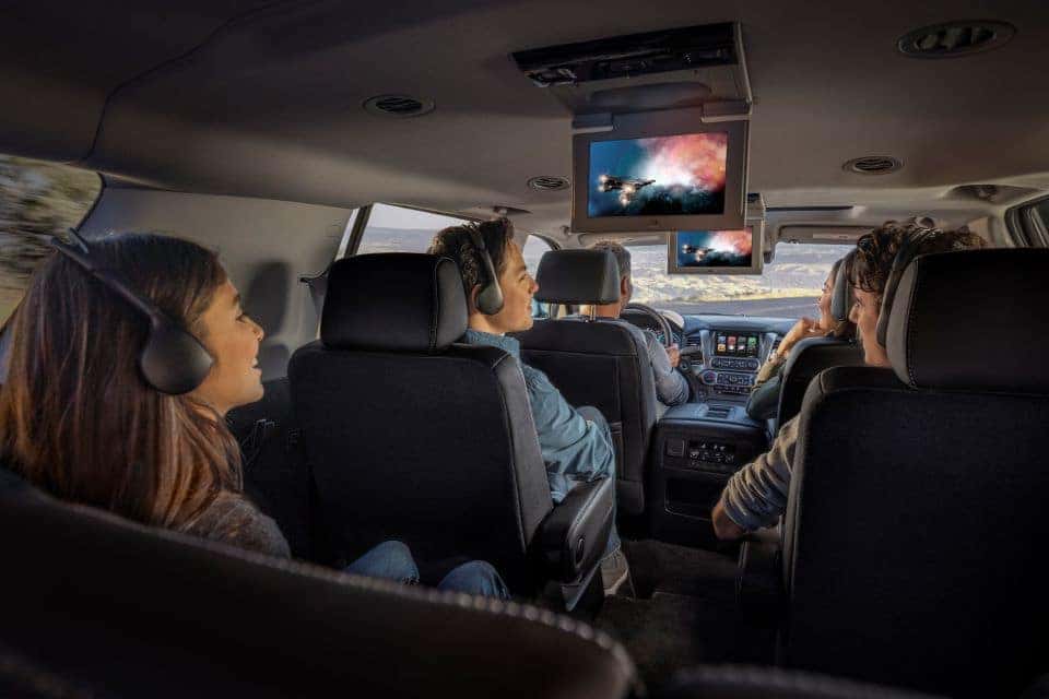 A family inside the Chevrolet Tahoe SUV watching the rear entertainment system