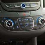 A close up photo of the climate control/AC system in a Chevrolet vehicle.