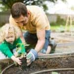 Father and Daughter Planting Garden