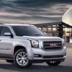 2016 GMC Yukon XL front view in front of modern building