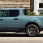 two people load the bed of a sea green 2023 maverick