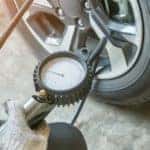 a mechanic fills a tire with air