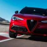 2019 Alfa Romeo Stelvio in red driving fast down the road